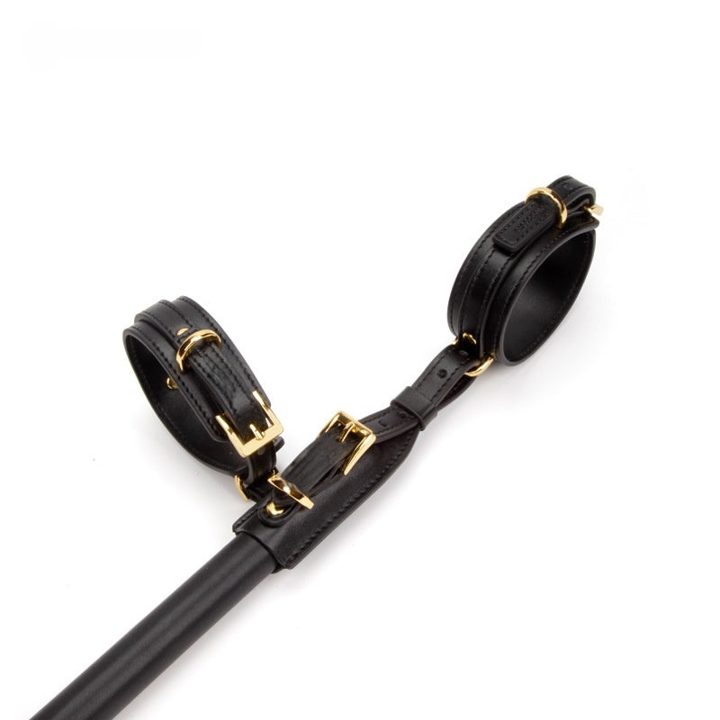 Wrist and ankle cuffs attached at one end of the MiaoMiss spreader bar, close-up view